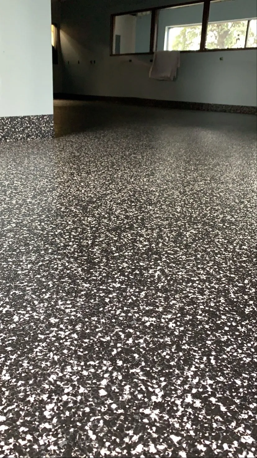 Black and white flake epoxy garage floor installed by Summit Surface Systems