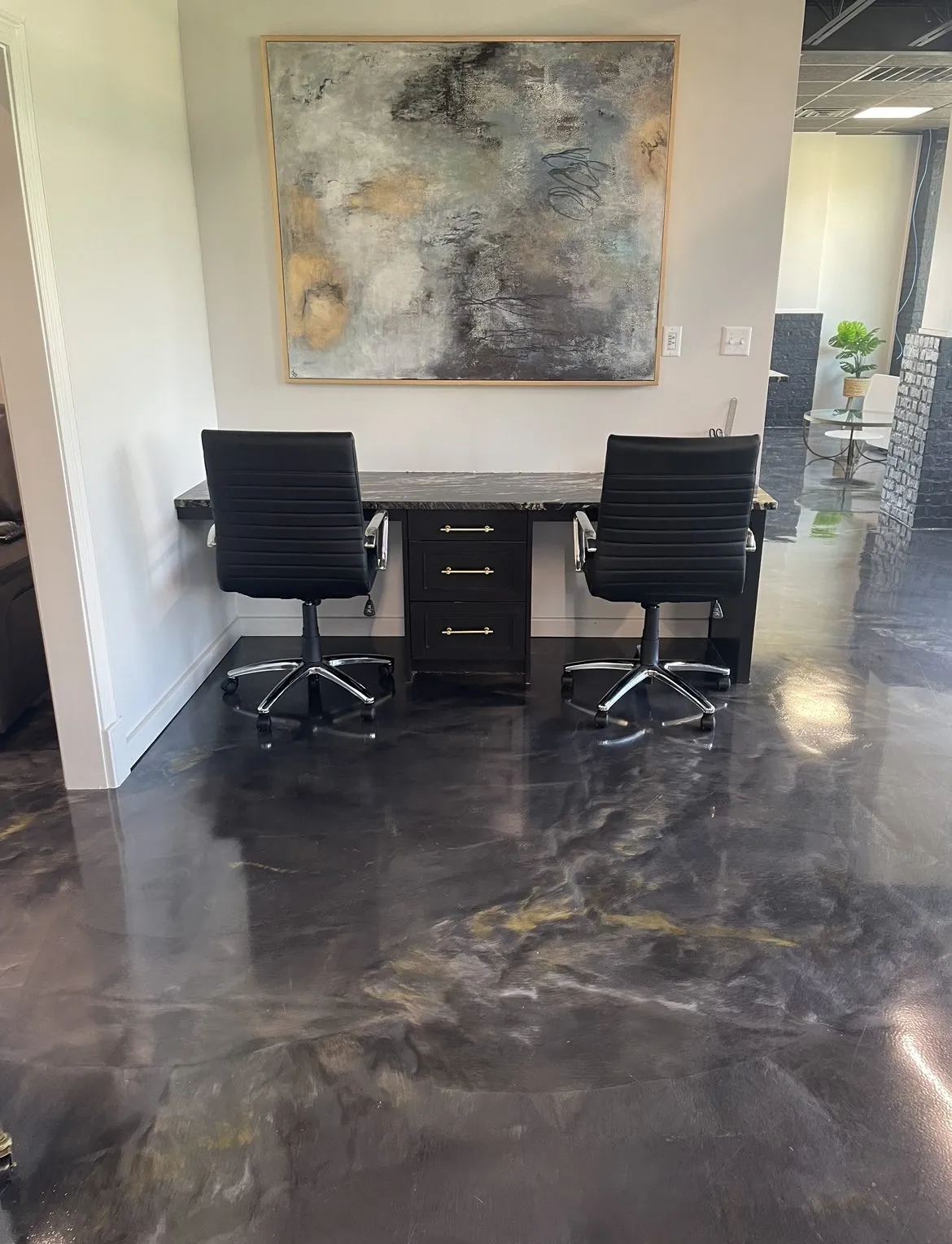 Black and gold decorative metallic epoxy floor in a commercial office