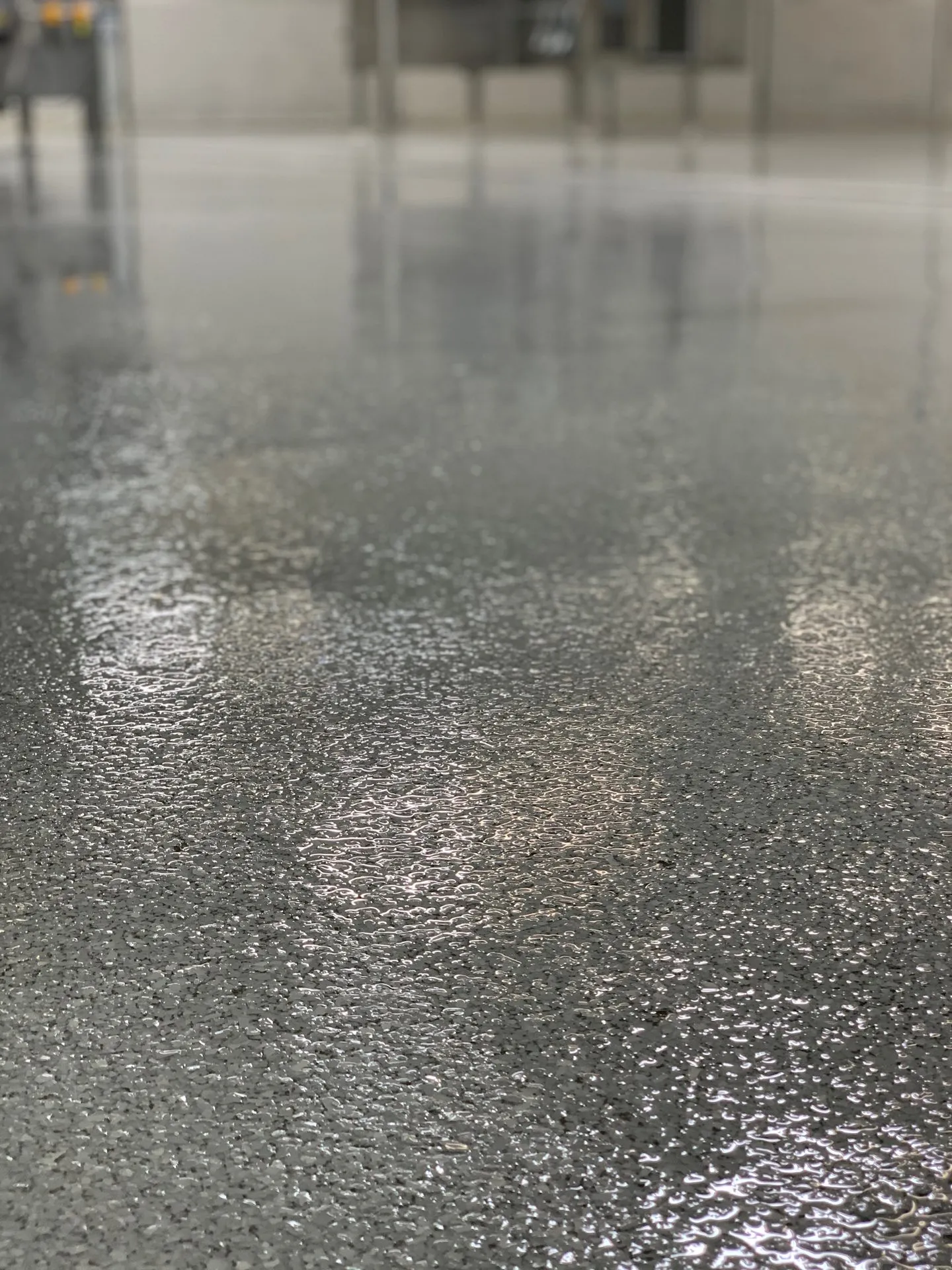 Close-up of a glossy gray flake epoxy floor coating