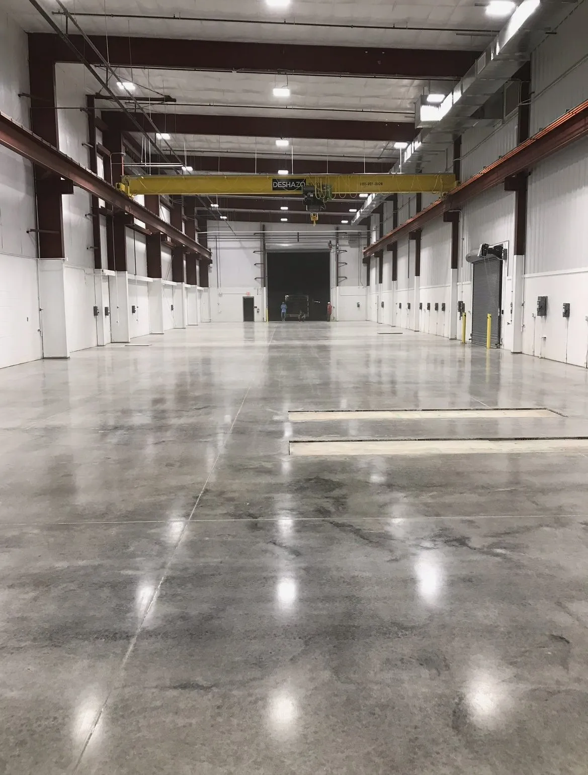Industrial warehouse floor coating installed under an overhead crane bay