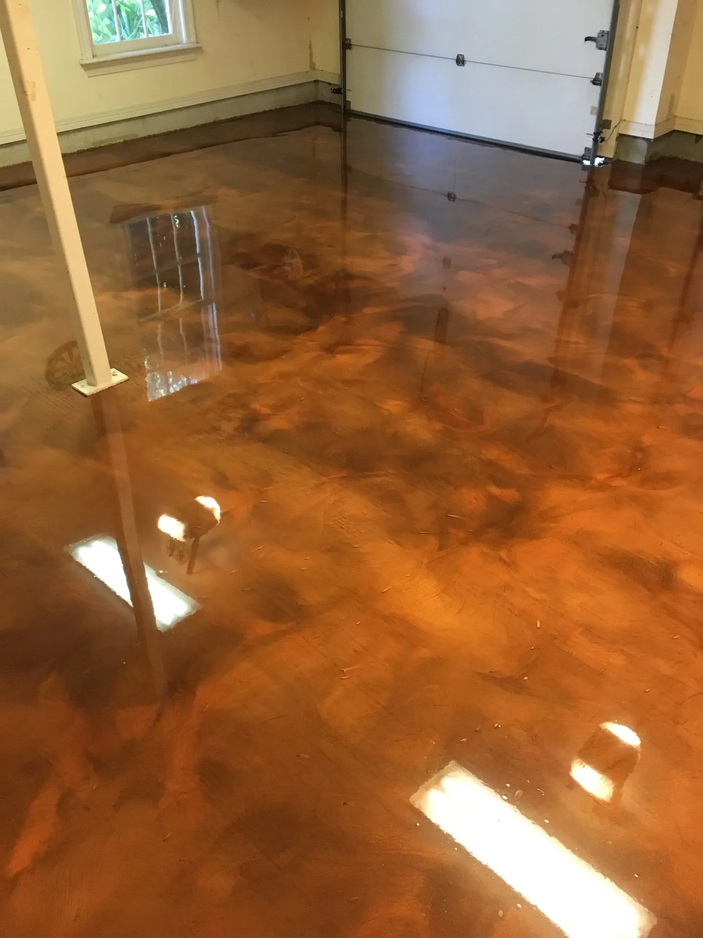 Bronze and brown metallic epoxy garage floor installed by Summit Surface Systems